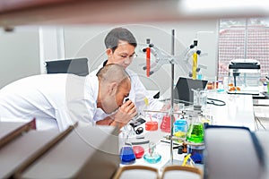 Male scientist standing with techer in lab