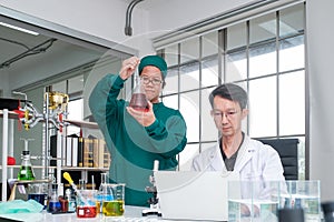 Male scientist standing with techer in lab