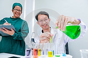 Male scientist standing with techer in lab worker making medical