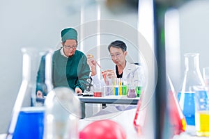 Male scientist standing with techer in lab worker making medical