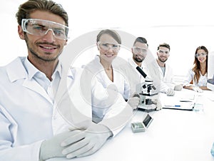Male scientist and the team in the lab.