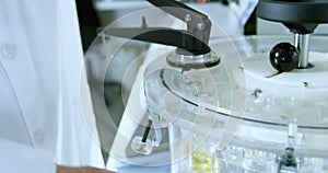 Male scientist using centrifuge machine in laboratory 4k