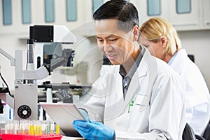 Male Scientist Using Tablet Computer In Laboratory