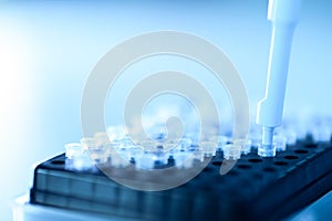 Male scientist working at the laboratory. Cloud up medical hand using micro pipette for test analysis. Scientific Lab for Medicine