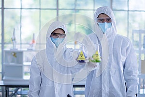 Male scientists and white female scientists are experimenting with chemicals in the laboratory.