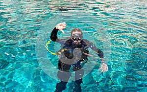 Male scuba diver gives 