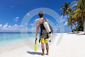 Male scuba diver is ready to go for a dive in the Maldives