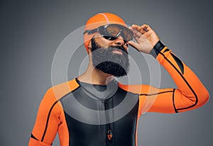 Male in scuba diving mask and orange neopren diving suit.