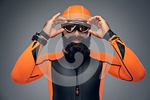 Male in scuba diving mask and orange neopren diving suit.