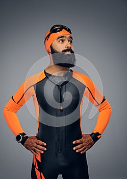 Male in scuba diving mask and orange neopren diving suit.
