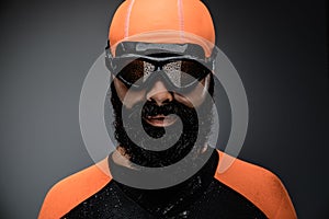 Male in scuba diving mask and orange neopren divingr suit.