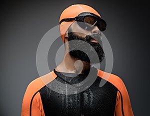 Male in scuba diving mask and orange neopren divingr suit.