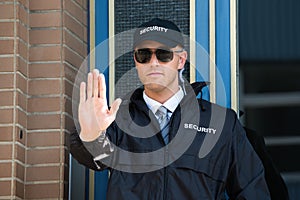 Male Security Guard Making Stop Sign With Hand