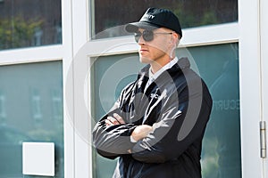 Male Security Guard Standing At The Entrance photo