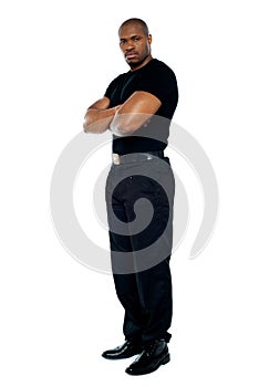 Male security guard with strong arms crossed