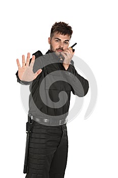 Male security guard in uniform using  radio transmitter on white background