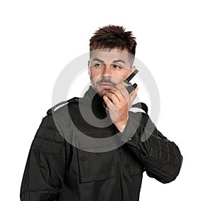 Male security guard in uniform using  radio transmitter on white background