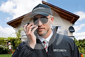 Male Security Guard Using Walkie-talkie