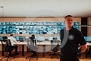 Male security operator working in a data system control room offices Technical Operator Working at workstation with