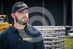 Male Security Team Member Outdoors As Stage For Music Festival Or Concert Is Set Up photo