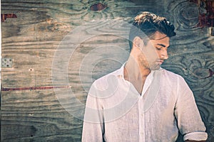 Male seduction. Young man in profile on antique wooden background.