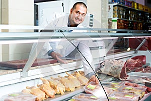 Male seller in halal section at supermarket