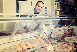 Male seller in halal section at supermarket