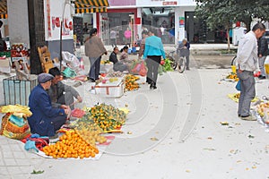 Men are selling mandarins at the fruits market, Xingping, China