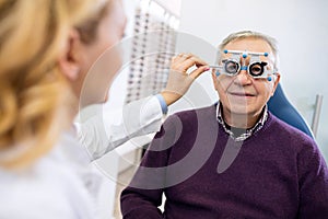 Male senior examine eyes