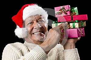 Male Senior Firmly Pointing At Six Wrapped Gifts