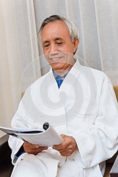 Male senior reading in hotel