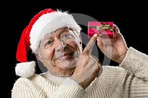 Male Senior With Red Pompom Hat And Christmas Gift