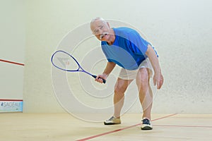 male senior tennis player indoors