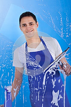 Male Servant Cleaning Glass With Squeegee