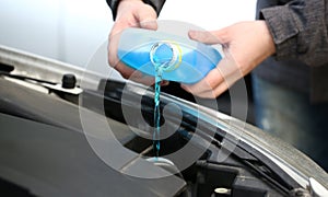 Male serviceman hands pouring blue washer