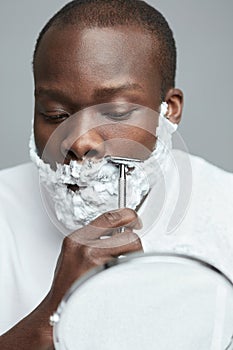 Male Shaving. Face Skincare Beauty Concept. Man Removes Facial Hair. Using Of Razor Shaver.