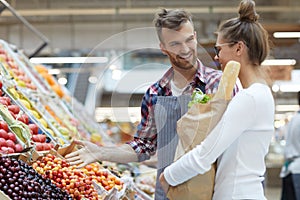 Male Shop Assistant Helping Customer