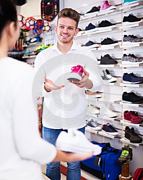 Male shop assistant helping customer