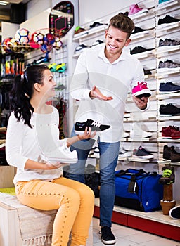 Male shop assistant helping customer