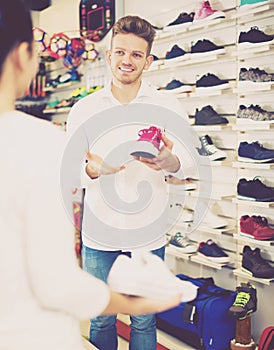 Male shop assistant helping customer