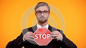 Male showing stop sign, rejecting discrimination, employees rights protection
