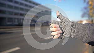 Male showing thumbs up to catch car, hitchhiking and travelling, adventure