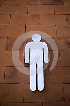 Male sign (symbol) for toilet on red brick background