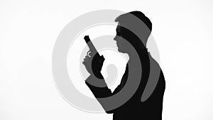 Male silhouette holding gun, preparing to shoot, revenge, contract killing