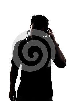 Male in silhouette listening to headphones