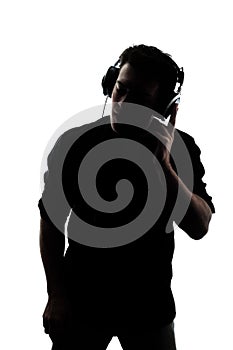 Male in silhouette listening to headphones