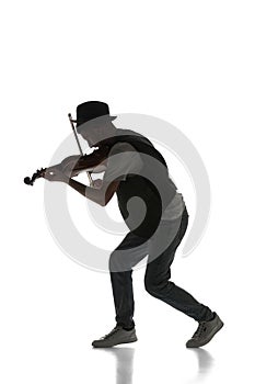 Male silhouette, musician playing violin isolated on white background. Black and white image.