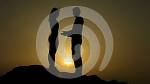 Male silhouette reaching out hands to girl, offering help, supportive friend