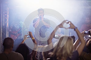 Male singer performing in front of crowd at nightclub