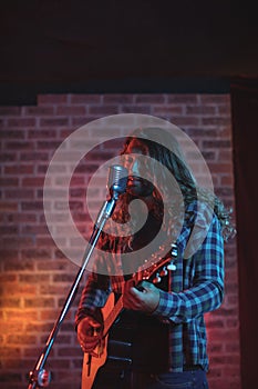 Male singer performing on stage in nightclub